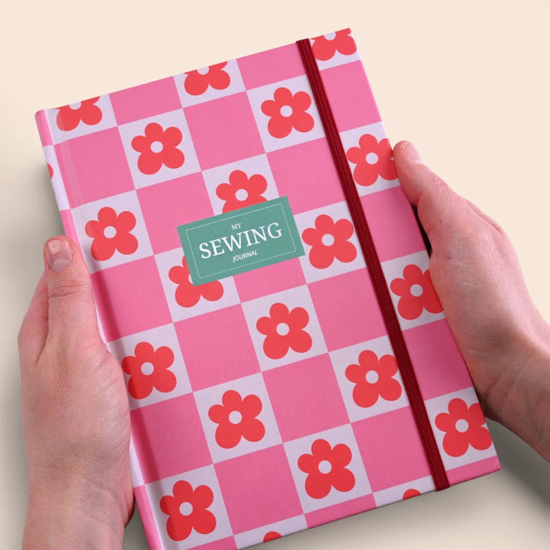 Open sewing journal with handwritten notes